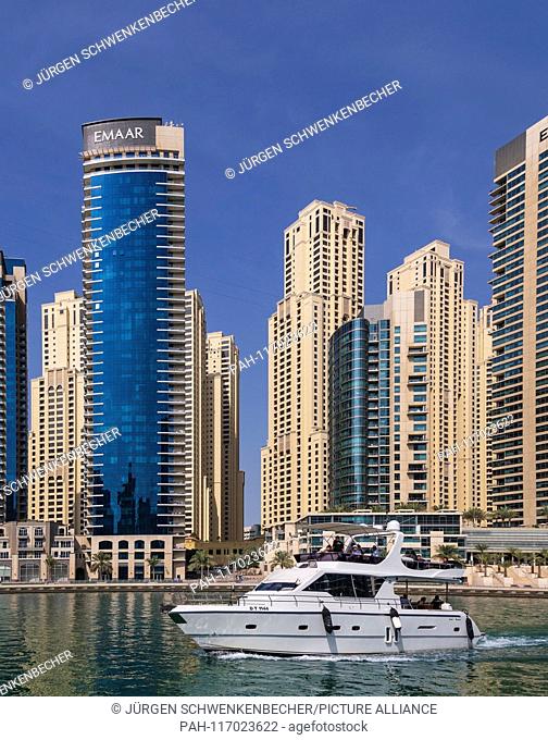 The skyscrapers are densely packed in the exclusive district of Marina Dubai. The impressive skyscrapers crowd around Marina Bay
