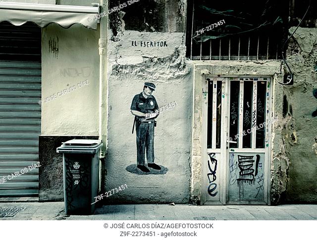 Police writing ticket, graffiti, Valencia, Spain
