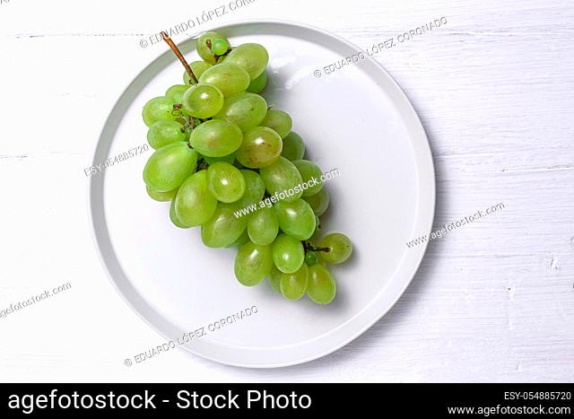 Fresh seasonal grapes in plate ready to eat On white background. Healthy food. Vegan food concept