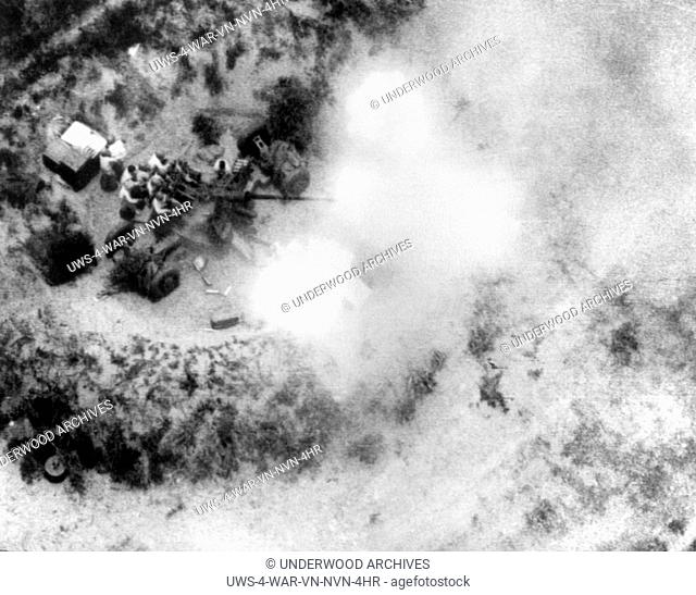 Thanh Hoa, Vietnam: February 25, 1966 Communist North Vietnamese gunners blaze away with a 57mm anti-aircraft gun at U.S