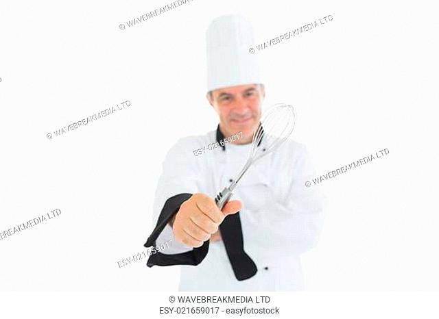 Mature chef holding wire whisk