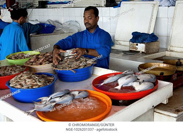 Fish mongers with fresh fish at the fish market in Sharjah, United Arab Emirates
