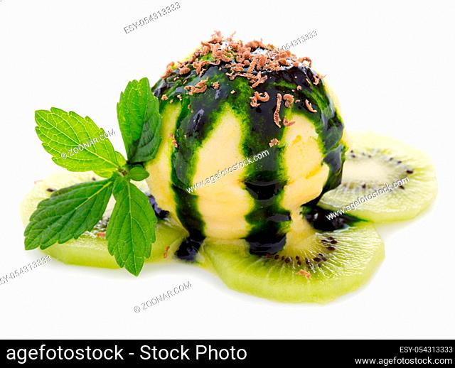 Vanilla ice cream dessert topped with kiwi syrup and served with fresh fruit on a white background