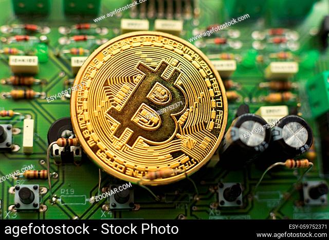 Bitcoin gold coin on computer circuit board microchips. Electronic cryptocurrency