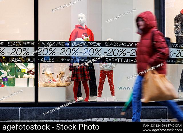 24 November 2023, Lower Saxony, Osnabrück: ""Black Friday"" can be read in the window of a store. Numerous stores and online stores celebrate Black Friday with...