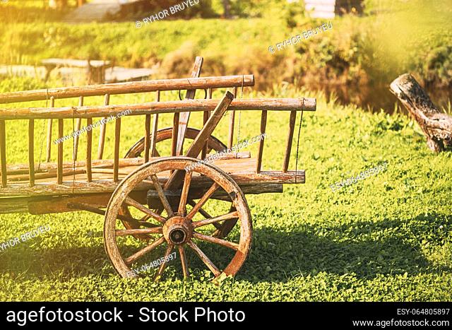 Decorative Peasant Cart On Summer Lawn. Bright Sunny Day. Garden Decoration Concept. Gardening And Housekeeping. Vintage Cart On Summer Sunny Day