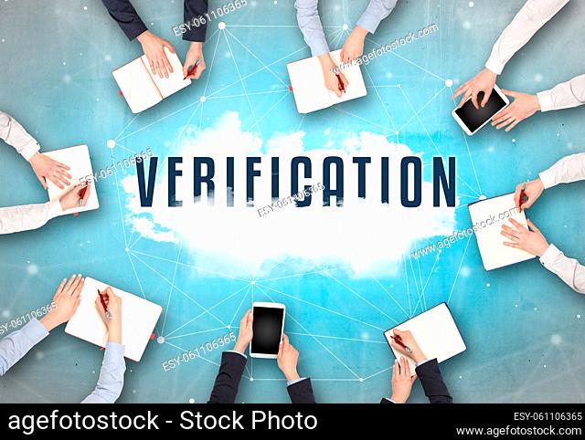 Group of people having a meeting with VERIFICATION insciption, web security concept