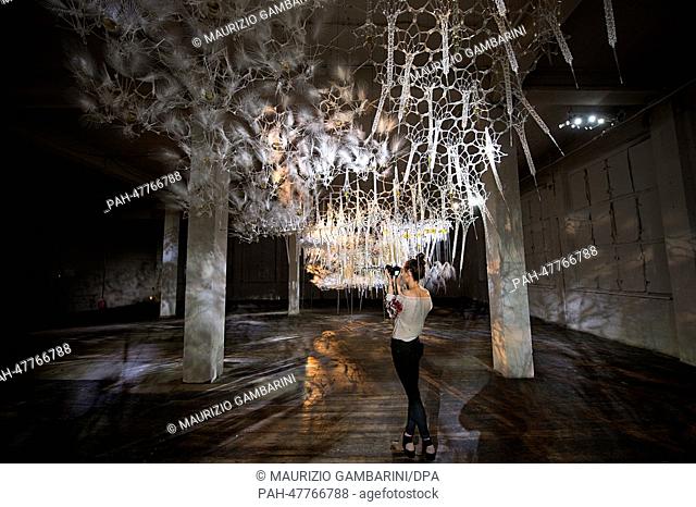 A visitor takes pictures of the installation 'Epiphyte Membrane' of the artist Philip Beesley during the exhibition project 'Photography Playground' in the...