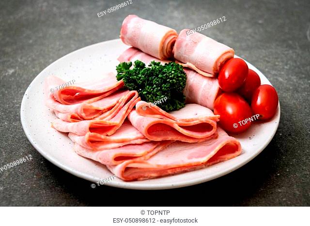 sliced raw pork bacon on plate