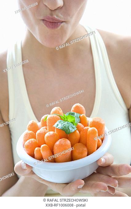 woman with bowl of carrots