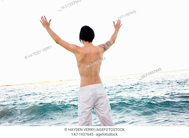 Man With Hands Up On Beach