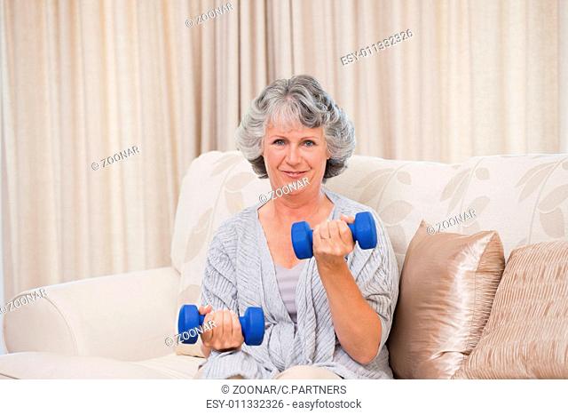 Woman doing her exercises on her sofa