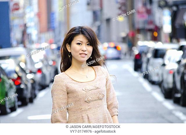 Japanese Girl poses on the street in Ginza, Japan. Ginza is a shopping city located in Tokyo