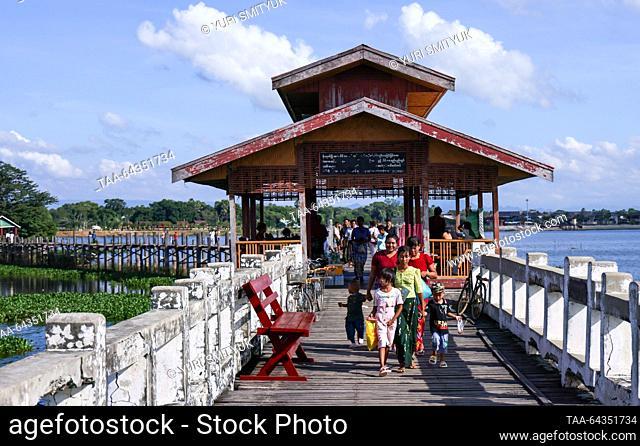 MYANMAR, MANDALAY - OCTOBER 25, 2023: People are seen on the U Bein Bridge spanning Lake Taungthaman. The 1.2-kilometre bridge is believed to be the world's...