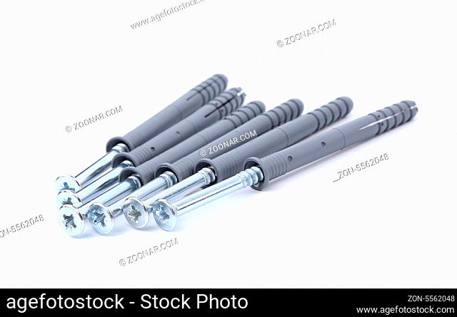 Screws and dowels isolated on white background