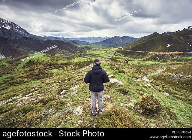 Woman looking at cantabrian landscape in San Emiliano Valley, Babia region (Leon province, region of Castilla y Leon, Spain)