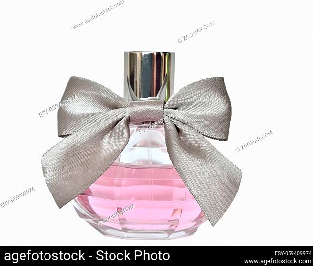 Women's perfume in beautiful round bottle with silver bow close up isolated on white background