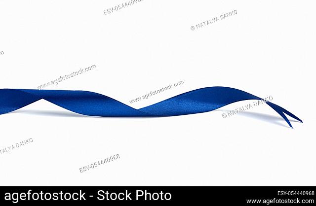 twisted dark blue silk ribbon isolated on white background, designer element for gift decor, close up