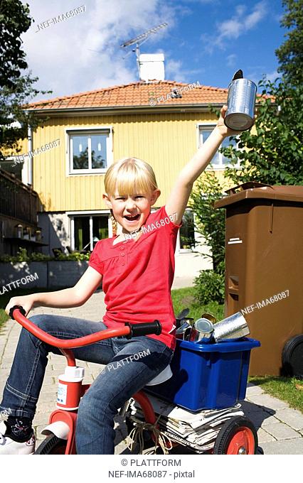 A girl with recycling objects on her bicycle Sweden