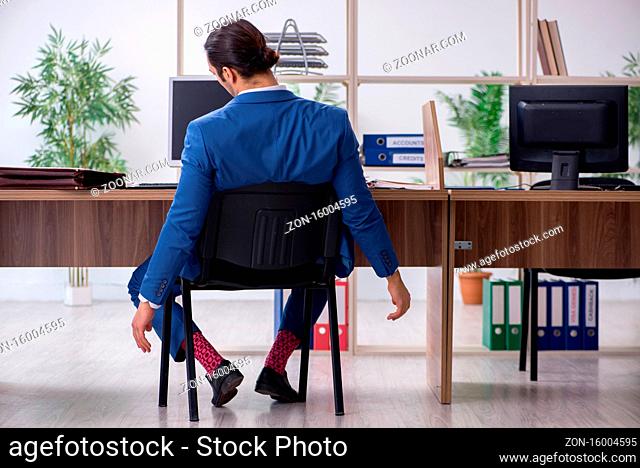 Young employee businessman at workplace