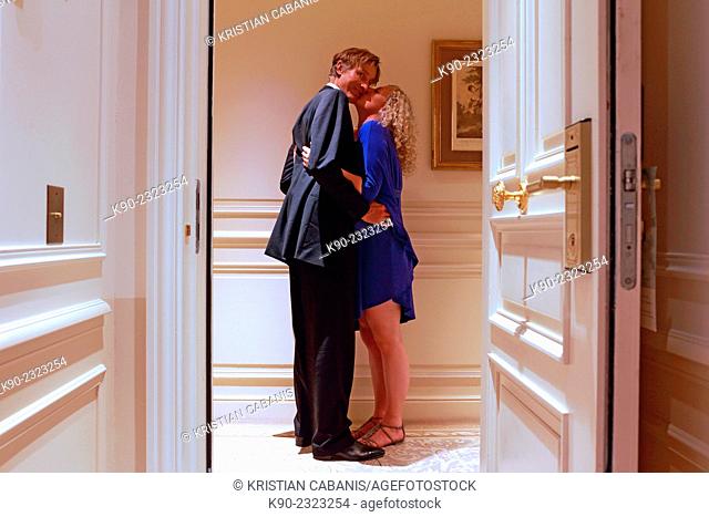 Caucasian man and woman kissing in front of the door of a hotel room, Hotel Hermitage, Monte Carlo, Monaco, Europe