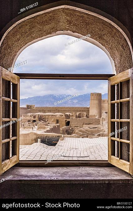 Ruins, towers and walls of the Rayen Citadel viewed through a window, Biggest adobe building in the world, Kerman Province, Iran, Asia