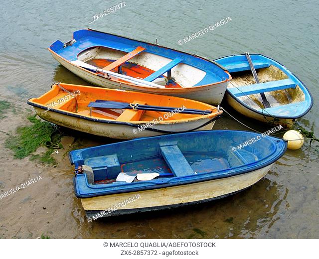 Small boats at Plentzia river bank on a rainy day. Plentzia village. Bizkaia province. Euskadi, Basque Country. Spain