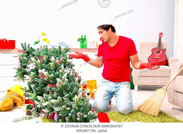 Man cleaning his apartment after christmas party