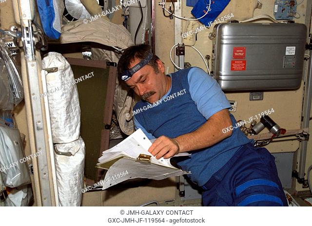 Cosmonaut Mikhail Tyurin, Expedition 14 flight engineer representing Russia's Federal Space Agency, installs and connects onboard equipment control system...