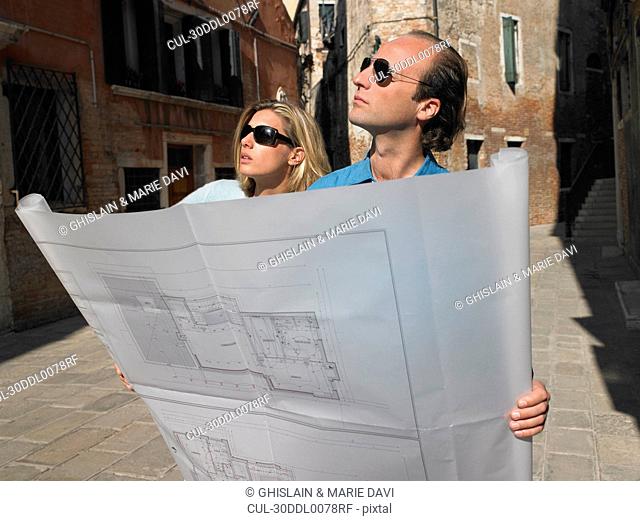 Couple looking at blue prints