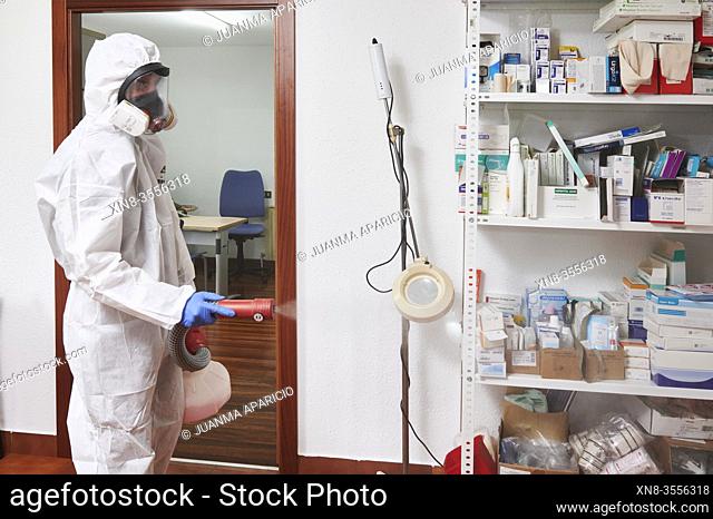 Technician disinfecting medical center with chemical detergents against Covid-19