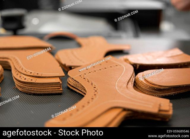 Different forms of leather pieces which will be use for making a shoes on a shoes factory. Prepared, bundled leather parts, used in the production of shoes