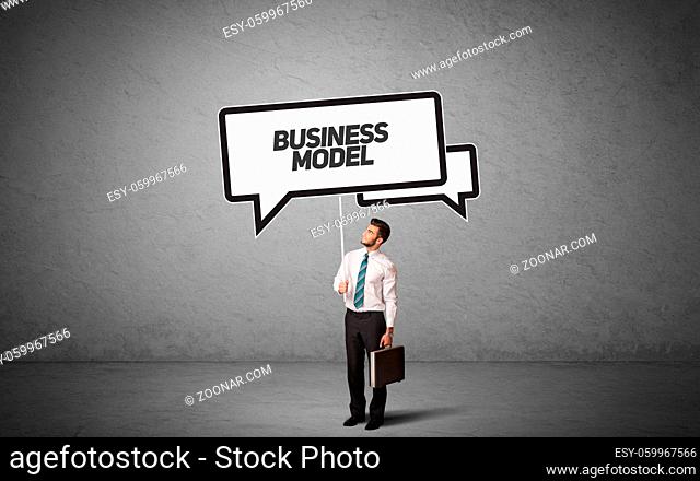 Young business person in casual holding road sign with BUSINESS MODEL inscription, new business idea concept