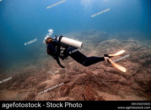 Woman swimming undersea at Del Coco beach