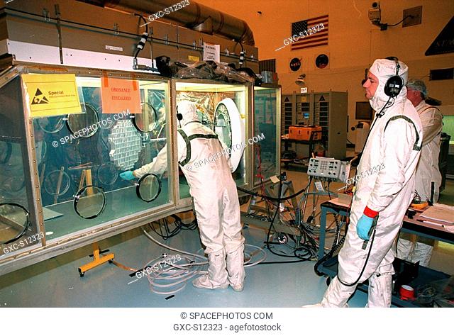 12/07/1998 --- In the Payload Hazardous Servicing Facility, workers inspect the aerogel grid from the Stardust Sample Return Capsule SRC to the right of the...