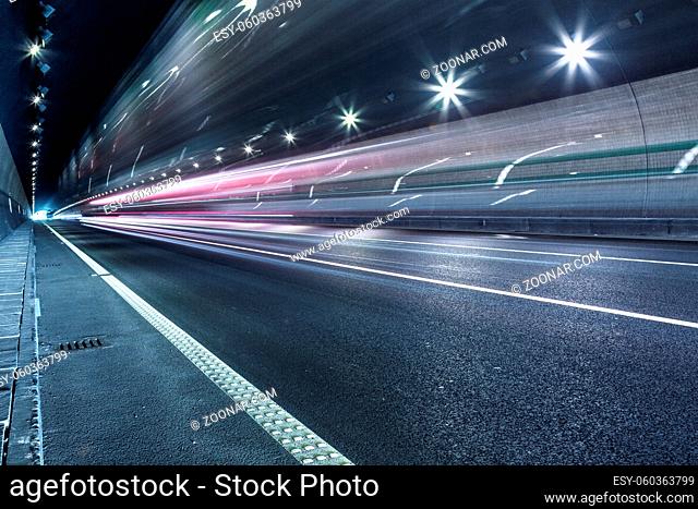 speeding lights of cars in city at night