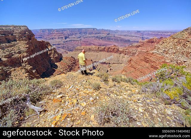 A man standing at a cliff west of Lipan Point at Grand Canyon South Rim Arizona
