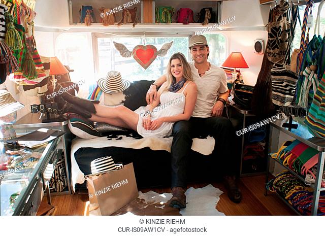 Portrait of couple in converted boutique airstream trailer