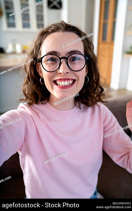 Cheerful woman with eyeglasses at home