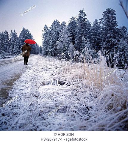 Poland, Winter scene, Woman with red umbrella