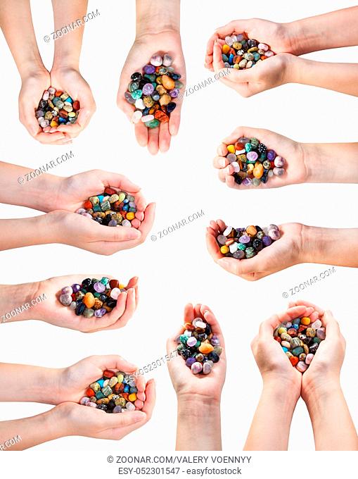 set of hands with handful of various natural gemstones isolated on white background