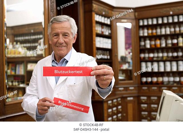 Pharmacist holding blood glucose test and blood pressure signs
