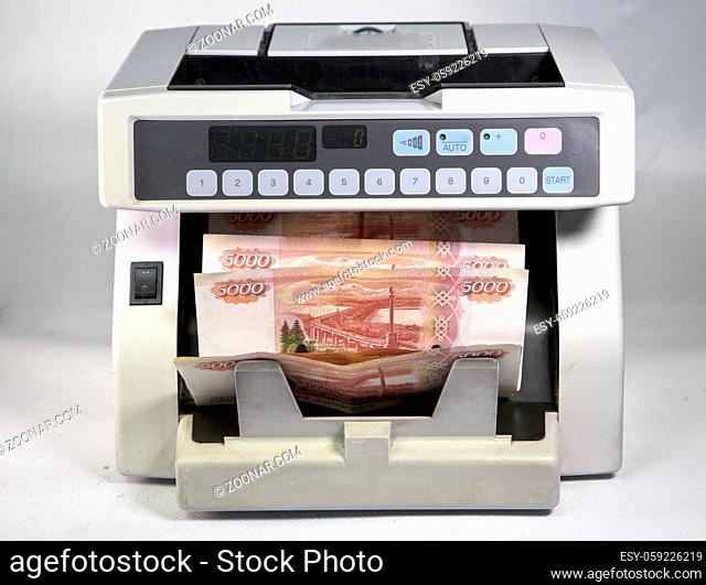 electronic money counter machine is counting the Russian five-thousandth ruble banknotes