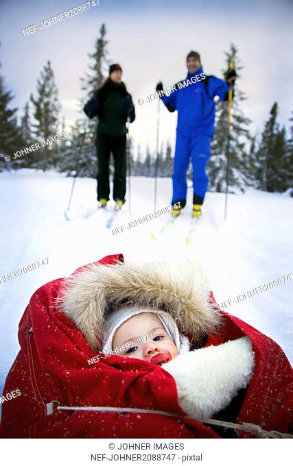Couple skiing with baby