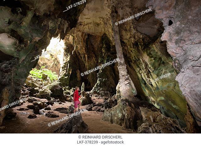 Tourist inside Kotilola Cave, Baliem Valley, West Papua, Papua New Guinea, New Guinea, Oceania