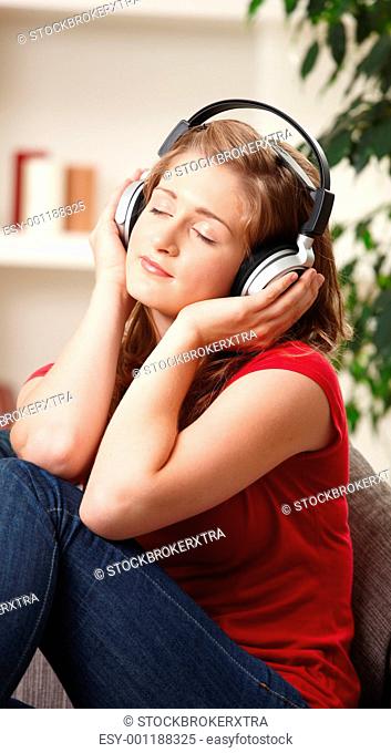 Teen girl listening to music at home