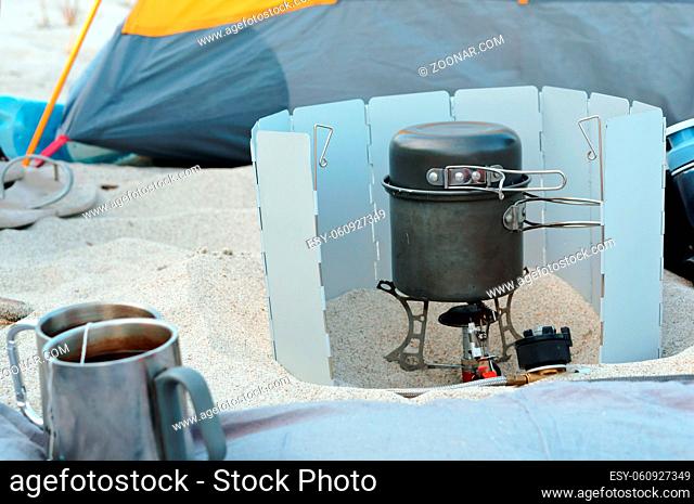 tourist cooking set, gas burner traveler, picnic on the sandy beach