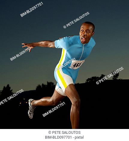 Black runner crossing finish line in race