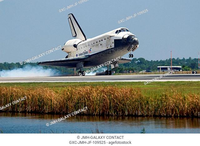 Space Shuttle Discovery touches down on runway 15 of the Shuttle Landing Facility at NASA's Kennedy Space Center, concluding the 14-day STS-124 mission to the...