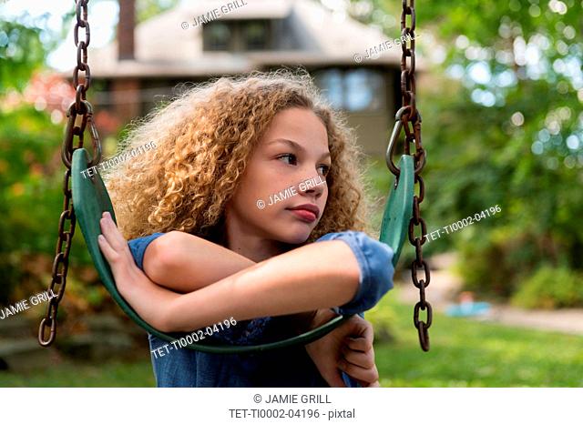 Girl leaning on swing